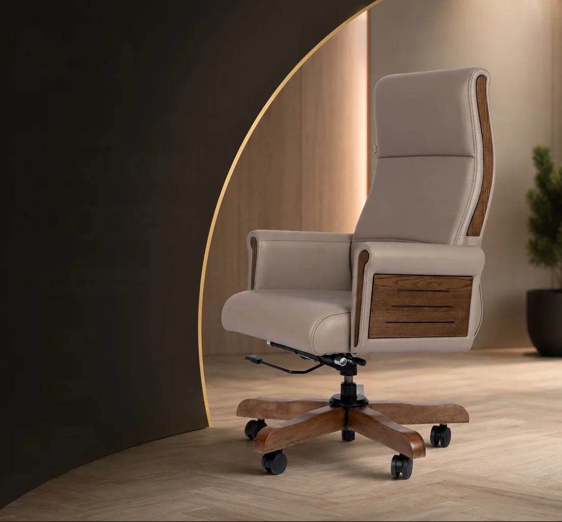 A taupe high-back executive chair with slatted wooden side panels, in a softly lit cabin